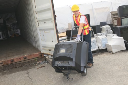 Different types of waste being loaded into a skip